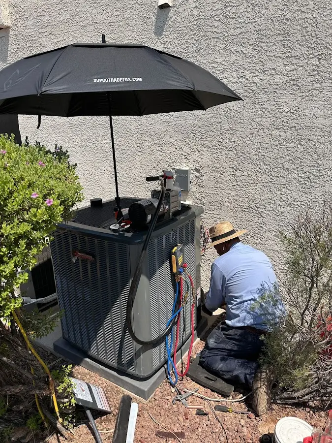 HVAC technician performing outdoor AC maintenance in South Brunswick