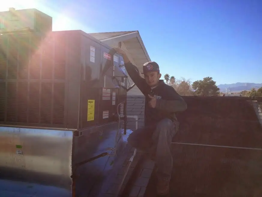HVAC technician performing Boiler Repair on a rooftop unit in South Brunswick